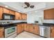 Spacious kitchen with stainless steel appliances and tile backsplash, and a view into the living area at 7550 Sunshine Skyway S Ln # T48, St Petersburg, FL 33711
