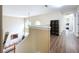 Upstairs hallway with hardwood floors and built-in shelving at 8810 Sandy Plains Dr, Riverview, FL 33578