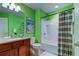 Bathroom with green walls, tub, and shower at 10280 Post Harvest Dr, Riverview, FL 33578