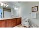 Double vanity bathroom with wood cabinets and large mirror at 10280 Post Harvest Dr, Riverview, FL 33578