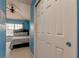 Blue bedroom with a queen-size bed and window at 10280 Post Harvest Dr, Riverview, FL 33578