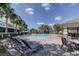 Inviting community pool with lounge chairs and shaded seating area at 10280 Post Harvest Dr, Riverview, FL 33578