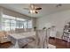 Well lit dining area with hardwood floors and white chairs at 10280 Post Harvest Dr, Riverview, FL 33578