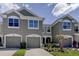 Two-story townhome with attached garage and landscaping at 10280 Post Harvest Dr, Riverview, FL 33578