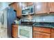Modern kitchen with stainless steel appliances and dark countertops at 10280 Post Harvest Dr, Riverview, FL 33578