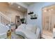 Elegant living room features a white couch and staircase at 10280 Post Harvest Dr, Riverview, FL 33578