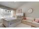 Main bedroom with plush bedding and adjacent sitting area at 10280 Post Harvest Dr, Riverview, FL 33578