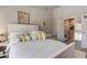 Main bedroom with plush bedding and access to bathroom and closet at 10280 Post Harvest Dr, Riverview, FL 33578