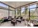 Relaxing screened porch with wicker furniture and lush greenery at 10280 Post Harvest Dr, Riverview, FL 33578