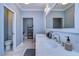 Bright bathroom featuring double sinks, marble countertops, and modern fixtures at 13181 Linzia Ln, Spring Hill, FL 34609