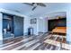 Spacious bedroom featuring wood-look floors and an en suite bathroom with a sliding door at 13181 Linzia Ln, Spring Hill, FL 34609