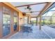 Covered patio featuring pavers, ceiling fans, and a dining set with seating for six at 13181 Linzia Ln, Spring Hill, FL 34609