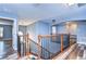 Hallway featuring wood-look floors, a wooden staircase, and neutral-toned walls at 13181 Linzia Ln, Spring Hill, FL 34609