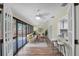 Inviting sunroom with multiple windows, cozy seating area, and bar area at 1497 Rosetree Ct, Clearwater, FL 33764