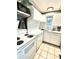 Small kitchen with white cabinets, tile backsplash and appliances at 2666 44Th S St, Gulfport, FL 33711