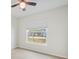 Bedroom with large window, tile flooring and ceiling fan at 5506 79Th E Ave, Palmetto, FL 34221