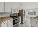 Modern kitchen with stainless steel appliances and light wood cabinets at 5506 79Th E Ave, Palmetto, FL 34221
