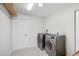 Well-equipped laundry room with modern washer and dryer, tiled floors, and ample space at 5506 79Th E Ave, Palmetto, FL 34221