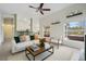 Bright living room featuring large windows, ceiling fan, neutral walls, and an open floor plan at 5506 79Th E Ave, Palmetto, FL 34221
