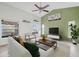 Bright living room featuring a comfy white couch and a large TV at 5506 79Th E Ave, Palmetto, FL 34221
