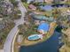 Community pool and tennis courts nestled by a lake at 5506 79Th E Ave, Palmetto, FL 34221