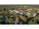 Aerial view of a modern building in a wooded neighborhood at 5727 Desert Rose Pl, Tampa, FL 33615