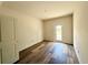 Bedroom featuring hardwood flooring and a glass door at 5727 Desert Rose Pl, Tampa, FL 33615