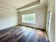 Open bedroom with large windows and hardwood floors. A glass door leads to the outside at 5727 Desert Rose Pl, Tampa, FL 33615