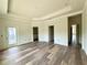 Large bedroom with hardwood floors and an outdoor balcony overlooking a residential neighborhood at 5727 Desert Rose Pl, Tampa, FL 33615