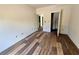 Bedroom with hardwood flooring and multiple entryways at 5727 Desert Rose Pl, Tampa, FL 33615