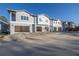Three-unit townhome building under construction, offering attached garages at 5727 Desert Rose Pl, Tampa, FL 33615