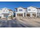 New townhome development featuring attached garages and modern design at 5727 Desert Rose Pl, Tampa, FL 33615
