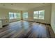 Bright, open living room with hardwood floors and multiple windows providing ample natural light at 5727 Desert Rose Pl, Tampa, FL 33615