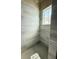 Modern shower with grey tiled walls and floors. A window is located on the back wall at 5727 Desert Rose Pl, Tampa, FL 33615