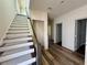 Staircase and hallway featuring hardwood flooring at 5727 Desert Rose Pl, Tampa, FL 33615