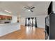 Living room with laminate floors and a view into the kitchen at 7908 E White Water Ct, Tampa, FL 33637