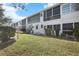 White building exterior with blue accents and lush landscaping at 8455 112Th St # 107, Seminole, FL 33772