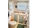 Clean bathroom with light blue vanity and wood-look flooring at 9790 66Th N St # 340, Pinellas Park, FL 33782