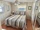 Cozy bedroom with striped bedding and mirrored closet doors at 9790 66Th N St # 340, Pinellas Park, FL 33782