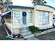 Inviting exterior of a manufactured home, featuring a landscaped yard and a charming entrance at 9790 66Th N St # 340, Pinellas Park, FL 33782
