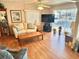 Bright living room with laminate flooring, comfortable seating, and a large TV at 9790 66Th N St # 340, Pinellas Park, FL 33782