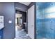Bathroom with blue walls, patterned tile, and access to another room at 13181 Linzia Ln, Spring Hill, FL 34609