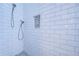 Bathroom with white tile shower and pebble floor at 13181 Linzia Ln, Spring Hill, FL 34609