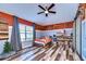 Rustic-themed bedroom with wood-paneled accent wall and sliding barn doors at 13181 Linzia Ln, Spring Hill, FL 34609