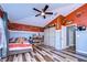 Rustic-themed bedroom with wood-paneled accent wall and sliding barn doors at 13181 Linzia Ln, Spring Hill, FL 34609