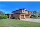 Two-story house with a large three-car garage and well-manicured lawn at 13181 Linzia Ln, Spring Hill, FL 34609