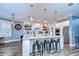 Modern kitchen with white cabinets, large island, and stainless steel appliances at 13181 Linzia Ln, Spring Hill, FL 34609