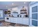 Modern kitchen with white cabinets, tile backsplash and wood flooring at 13181 Linzia Ln, Spring Hill, FL 34609