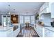 Modern kitchen with white cabinets, large island, and stainless steel appliances at 13181 Linzia Ln, Spring Hill, FL 34609