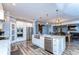 Modern kitchen with white cabinets, large island, and stainless steel appliances at 13181 Linzia Ln, Spring Hill, FL 34609